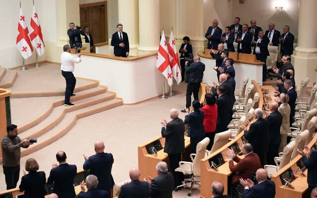 Georgian president-elect Mikheil Kavelashvili is greeted by the electoral college members at the Georgian parliament, in Tbilisi, Georgia, December 14, 2024.