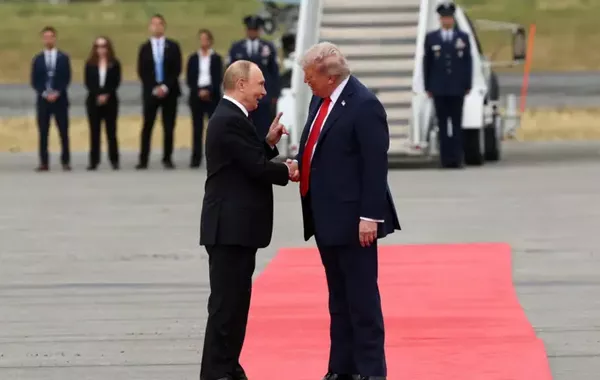 Trump and Putin shake hands